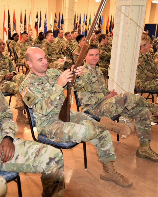 Capt. Jonathan Vallone, strength manager for U.S. Army Sustainment Command, observes a British Short Land Pattern Musket during a staff ride at Rock Island Arsenal, Illinois, July 20. (Photo by Capt. Jackeline Velazquez, ASC Public Affairs)