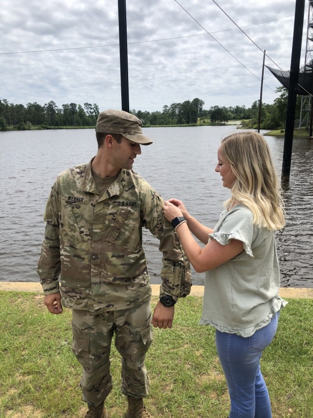 1st Lt. Conner Webber assigned to 3rd Battalion, 15th Infantry Regiment, 2nd Armored Brigade Combat Team, 3rd Infantry Division, is pinned by his spouse Jordan Webber after earning the prestigious Ranger Tap at Fort Benning, Georgia, June 25,...