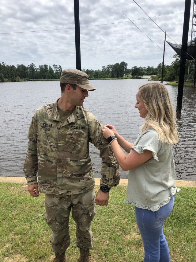 1st Lt. Conner Webber assigned to 3rd Battalion, 15th Infantry Regiment, 2nd Armored Brigade Combat Team, 3rd Infantry Division, is pinned by his spouse Jordan Webber after earning the prestigious Ranger Tap at Fort Benning, Georgia, June 25, 2021. (Courtesy Photo)