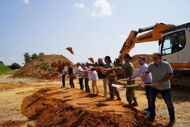 Starting third from right: Command Sgt. Maj. Christopher Carbone and Commander Lt. Col. Mark Bush, both with 3rd Squadron, 2nd Cavalry Regiment, break ground alongside Amberg Lord Mayor Michael Cerny, Amberg city council members and housing...