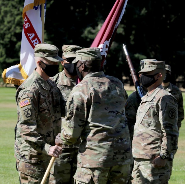 Lt. Gen. R. Scott Dingle, center, the Army Surgeon General and commanding general of U.S. Army Medical Command, passes the colors to Brig. Gen. Edward H. Bailey, incoming commanding general of RHC-P, during the change of command ceremony, July 26,...