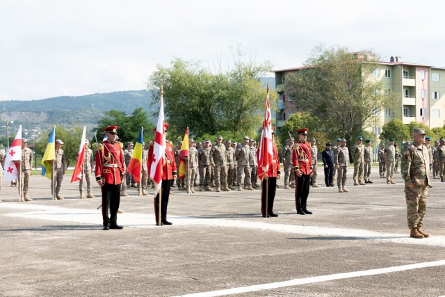 U.S. and allied soldiers participating in Exercise Agile Spirit 2021 stand at attention during the opening ceremony July 26, 2021, at Senaki Air Base, Georgia. Agile Spirit 21 promotes regional stability and security, while increasing readiness,...