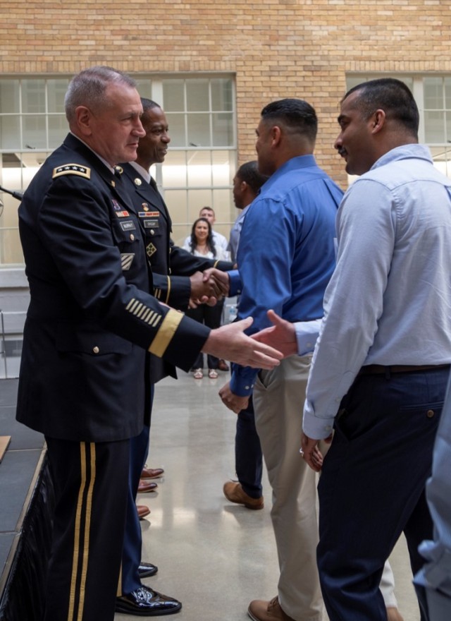 Gen. Murray and CSM Crosby of Army Futures Command congratulate Software Factory cohort members.