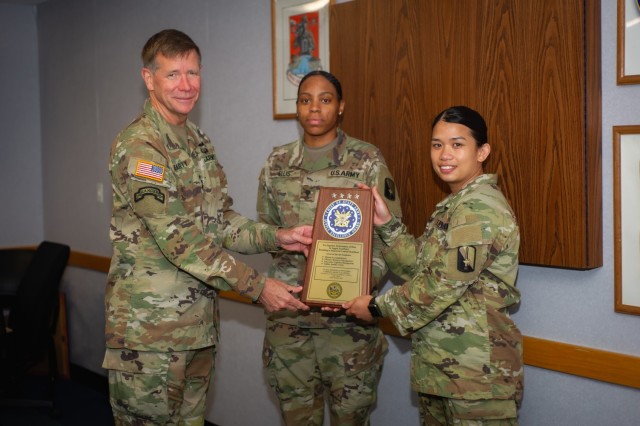 U.S. Army Sgt. Angelu Legaspi and Spc. Cierra Ellis, assigned to 55th Signal Company (Combat Camera), are awarded for winning the Chief of Staff, Army, Supply Excellence Award Program (SEA) by Lt. Gen. Stephen Fogarty, the commander of the U.S....
