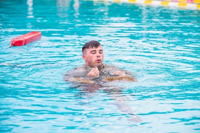 Army Staff Sgt. Edward Nelan competes in the water survival portion of the 2021 U.S. Army Medical Command Best Leader Competition on July 26, 2021, at Schofield Barracks on the Island of Oahu, Hawaii. Nelan is a Brooke Army Medical Center Soldier Recovery Unit squad leader representing Regional Health Command-Central in the year’s competition. The winning Soldier and Noncommissioned Officer will compete to be the Army’s Best Warrior in the Army Best Warrior Competition, which will take place in the fall. (U.S. Army Photo by Cpl. Andrew Garcia)