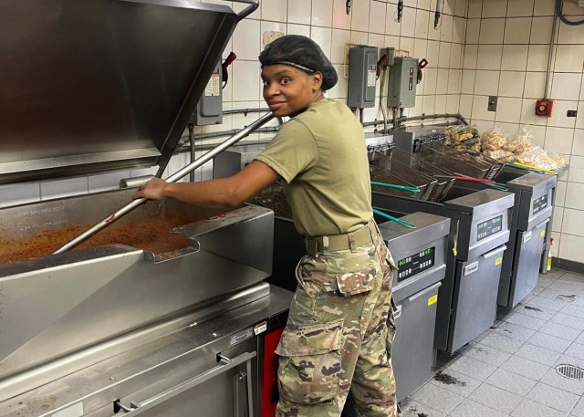 Army Reserve Sgt. Nicole Hall, who deployed to the U.S. Central Command area of operations at Camp Arifjan, Kuwait, with the Indianapolis-based 310th Sustainment Command (Expeditionary), stirs chili at the North Dining Facility at Bagram Airfield, Afghanistan during her 29-day assignment there which ended July 2, 2021, when the DFAC closed. Hall is one of four "Brickyard" Army culinary specialists, or 92G's, tasked to support the dining facility that served hot meals to both Coalition and U.S. forces. (Photo courtesy of Sgt. Nicole Hall)