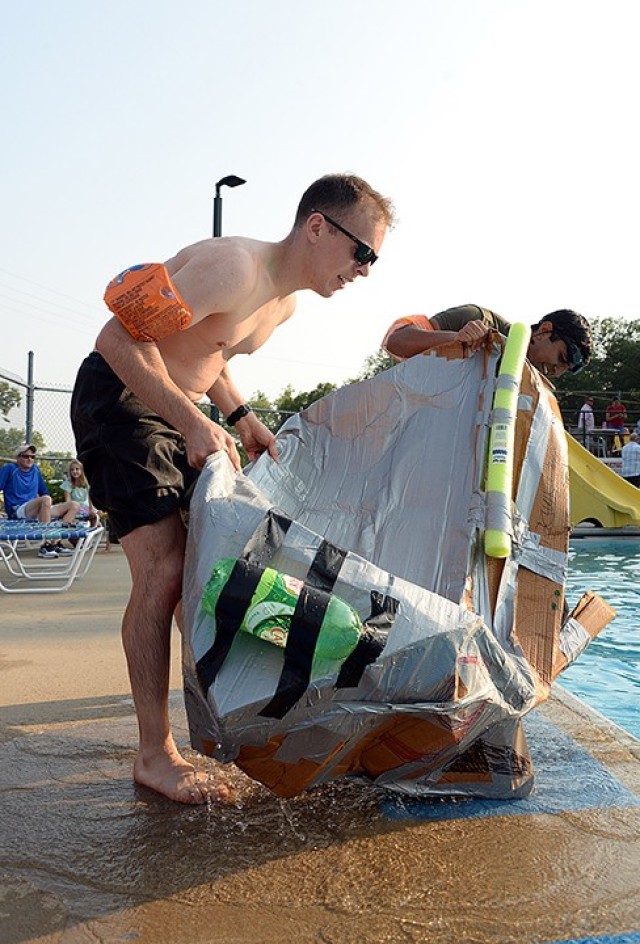 Seminar 5 competitors Maj. Michael Pierri and Pakistani Maj. Yasin Javed drain the water from their collapsed boat after recovering it from the pool during the School of Advanced Military Studies Boatyard Warz July 22 at Hancock Pool. Photo by...