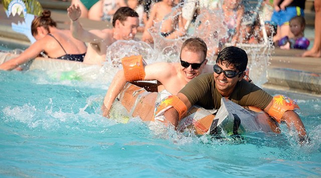 Seminar 5 competitors Maj. Michael Pierri and Pakistani Maj. Yasin Javed paddle toward the pool edge to complete their first lap after colliding with Seminar 8 competitors British Maj. Philip Anderson and Maj. Megan OKeefe on their return lap...