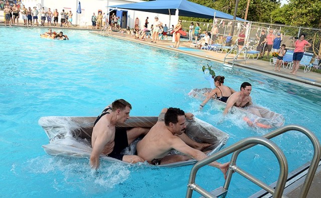 Seminar 3 competitors Navy Lt. Mark Carrion and Maj. Jaridd Leute near the edge of the pool to begin their return lap of the pool while racing against British Maj. Philip Anderson and Maj. Megan OKeefe of Seminar 8, right, and Pakistani Maj. Yasin...