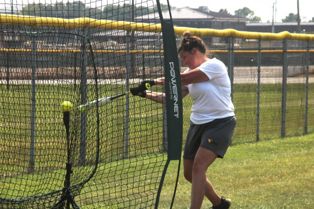 Staff Sergeant Kathryn Pena, 1st Brigade Combat Team, 101st Airborne Division (Air Assault), takes practice swings off the tee July 23 at Fort Campbell. Tryouts started July 22 and will continue through Aug. 2 when coaching staff makes the final...