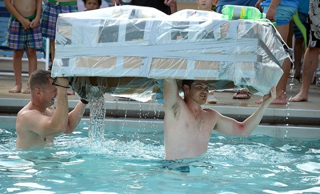 Advanced Strategic Leadership Studies Program students Marine Lt. Col. Peter Preister and Troy Tillis salvage their team's boat from the water near the end of their return lap in the second heat of the School of Advanced Military Studies Boatyard...