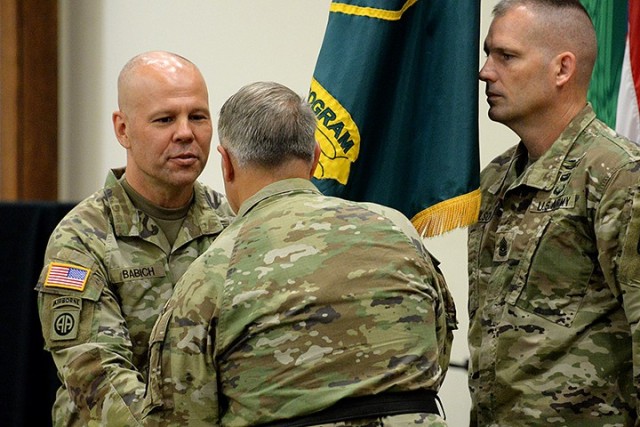 Incoming Mission Command Training Program Commander Col. Bryan Babich accepts the colors from Brig. Gen. Charles Lombardo, deputy commanding general of Combined Arms Center – Training, before passing them back to MCTP Command Sgt. Maj. Joseph...