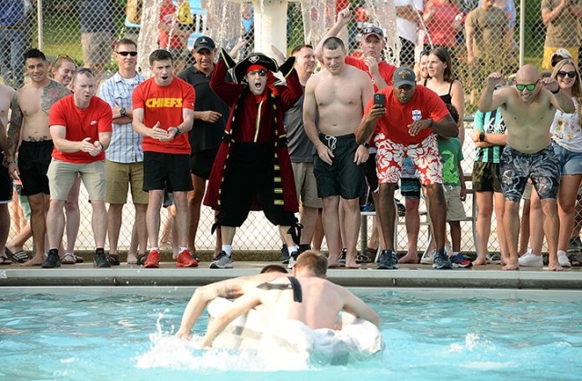 School of Advanced Military Studies students cheer as Seminar 3 competitors Navy Lt. Mark Carrion and Maj. Jaridd Leute race to successfully complete their return lap of the pool during the third heat of the SAMS Boatyard Warz races July 22 at...