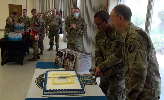 The oldest and youngest members of the Fort Huachuca, Ariz. religious support team cut a cake to celebrate the 246th Birthday of the U.S. Army Chaplain Corps.