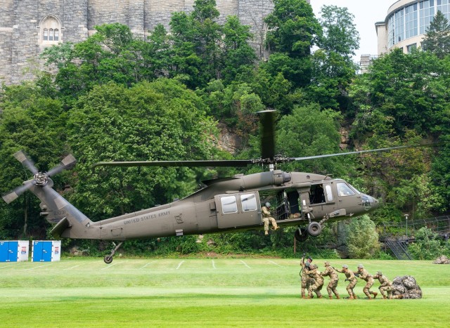 A group of cadets, who are trainees, attach their bags for a sling load during The Sabalauski Air Assault School course at West Point July 21 on a field on South dock. 	(Photo by Ellen Wilhelm/West Point Public Affairs Intern)