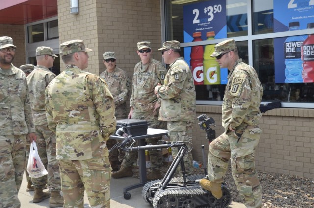 Soldiers assigned to 52nd Ordnance Group (Explosive Ordnance Disposal) showcase a static display including a bomb robot and other specialized equipment to draw attention July 21 during an EOD Hiring Day at the Gate 10 Express.