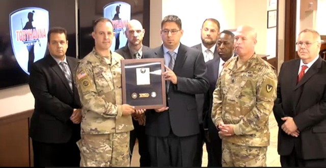 Mr. Christopher Gogola (Lead Process Improvement Specialist) accepts the 2020 Lean Six Sigma Excellence Award for Process Improvement Non-Enterprise Level Black Belt Project on behalf of U.S. Army Materiel Command, Communications-Electronics Command Ground Systems.