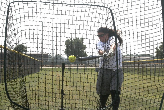 Sergeant Megan Hearn, 1st Battalion 214th Aviation Regiment, Wiesbaden Germany, takes practice swings off the tee July 23 at Fort Campbell. Tryouts started July 22 and will continue through Aug. 2 when coaching staff makes the final cut. This is...