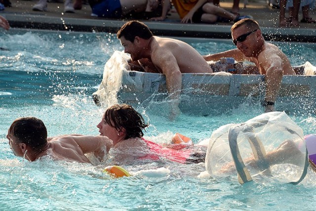 Seminar 6 competitors Maj. Greg Shepard and Maj. Nicole Chappell, on their "minimalist" watercraft, and Advanced Strategic Leadership Studies Program competitors Troy Tillis and Marine Lt. Col. Peter Preister, in their cardboard boat, launch from...
