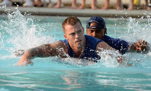 School of Advanced Military Studies students Maj. Jeff Ellingsen and Maj. Dino Buchanan of Seminar 2 try to keep pace with other SAMS Boatyard Warz competitors during the first heat of races July 22 at Hancock Pool. Photo by Prudence Siebert/Fort...