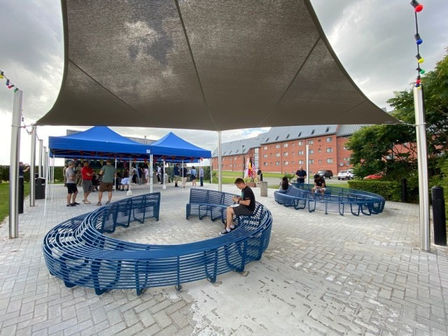 Single service members enjoy new benches at their new barbecue area July 25 at Chièvres Air Base, Belgium. U.S. Army Garrison Benelux officially opened the barbecue area at the single service member quarters. (U.S. Army photo by Libby Weiler,...