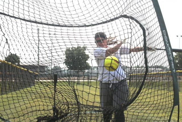 Sergeant Megan Hearn, 1st Battalion 214th Aviation Regiment, Wiesbaden Germany, takes practice swings off the tee July 23 at Fort Campbell. Tryouts started July 22 and will continue through Aug. 2 when coaching staff makes the final cut. This is...