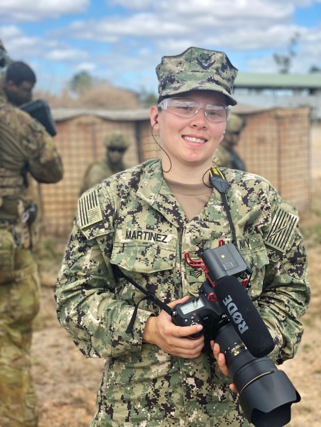 Mass Communication Specialist 1st Class Jen S. Martinez, a member of the Combined Joint Information Bureau, covers U.S. Marines and Australian Defence Force during a combined urban clearance during Exercise Talisman Sabre 21 in Townsville Training Area, Queensland, Australia, July 27, 2021. She is a Navy Reservist with Navy Office of Information, U.S. Pacific Fleet, and is on her first annual training. Australian and U.S. Forces combine biennially for Talisman Sabre, a month-long multi-domain exercise that strengthens allied and partner capabilities to respond to the full range of Indo-Pacific security concerns. (U.S. Navy photo by Lt. Travis Weger)