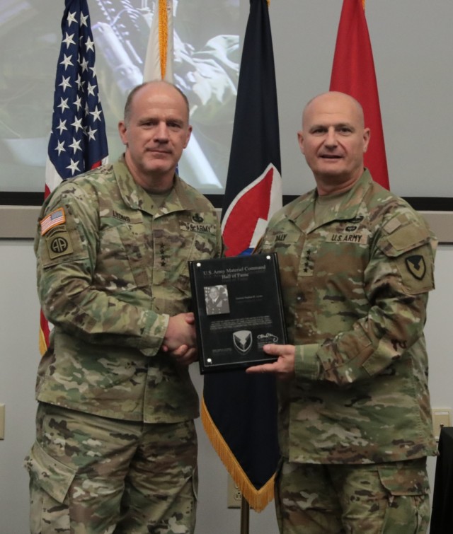 Army Materiel Command commander Gen. Ed Daly inducts retiring Gen. Stephen Lyons into the AMC Hall of Fame during the Army Sustainment Leader Summit at AMC Headquarters, Redstone Arsenal, Ala., July 30. (U.S. Army Photo by Kim Hanson)