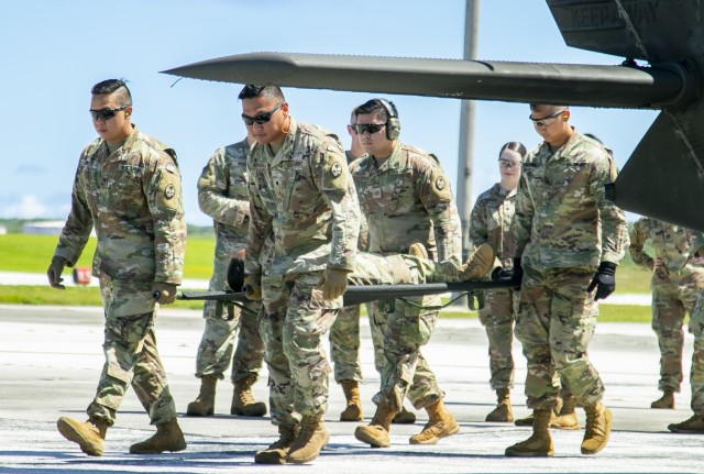 Soldiers with the 62nd Medical Brigade and Guam National Guard practice treating and loading patients onto a Sikorsky UH-60 Black Hawk helicopter, under the guidance of the 1-52 General Support Aviation Battalion, during a medical training event as part of Forager 21 at Andersen Air Force Base, Guam, July 28, 2021. (U.S. Army photo by Spc. Richard Carlisi, I Corps)