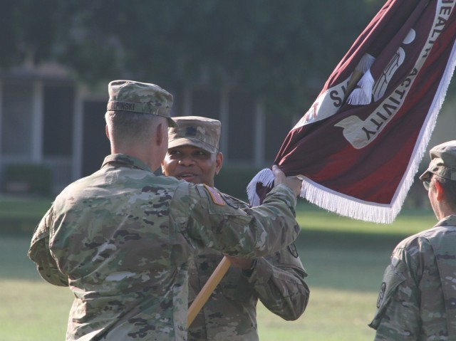 Lt. Col. Demarcio Reed receives the unit colors from Col. Stefan Olpinski, Dental Health Command-Central commander, during the Fort Sill Dental Activity change of command ceremony July 29, 2021. The ceremony was held at the historic grounds of the Old Post Quadrangle on Fort Sill, Oklahoma.