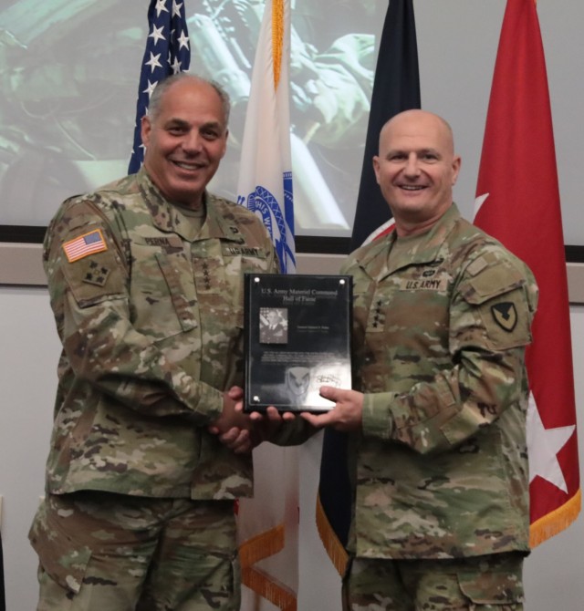Army Materiel Command commander Gen. Ed Daly inducts retiring Gen. Gus Perna into the AMC Hall of Fame during the Army Sustainment Leader Summit at AMC Headquarters, Redstone Arsenal, Ala., July 30. (U.S. Army Photo by Kim Hanson)