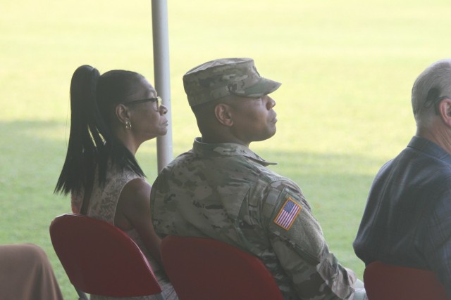 Seated with his mother, Cassandra Reed, Lt. Col. Demarcio Reed listens to Col. Stefan Olpinski’s speech during the change of command ceremony July 29, 2021, at Fort Sill, Oklahoma. Reed thanked his mother for attending most of his significant moments in his Army career.