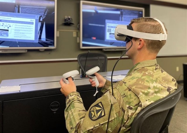 A role player utilizes the Oculus Quest 2 virtual reality headset to interact within a virtual command post during the Mission Command Battle Lab’s Technical Excursion with Cross Reality-Common Operating Picture (XR-COP).