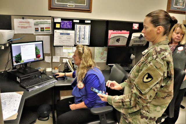 Fort McCoy Commissary Store Manager Kim Graham shows Command Sgt. Maj. Raquel DiDomenico, garrison command sergeant major, how to sign up for an account July 26, 2021, for the CLICK2GO online ordering and curbside service at the Fort McCoy...