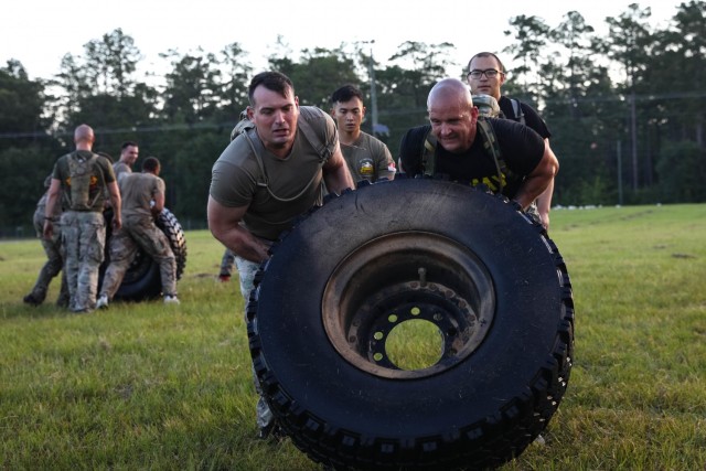 Soldiers from 6th Squadron, 8th Cavalry Regiment, 2nd Armored Brigade Combat Team, 3rd Infantry Division, Fort Stewart, Georgia work as a team to finish the tire flip portion of the Iron Spartan Fitness Competition at Fort Stewart, Georgia. The comprehensive, timed competition sought to build a team inside a team in company formations, demonstrate the physical capability of an armored brigade combat team, and show that “People First” really means preparing Soldiers to fight, win, and come home from the nation’s wars through tough, realistic training. (U.S. Army photo by Pfc. Caitlin Wilkins, 50th Public Affairs Detachment)