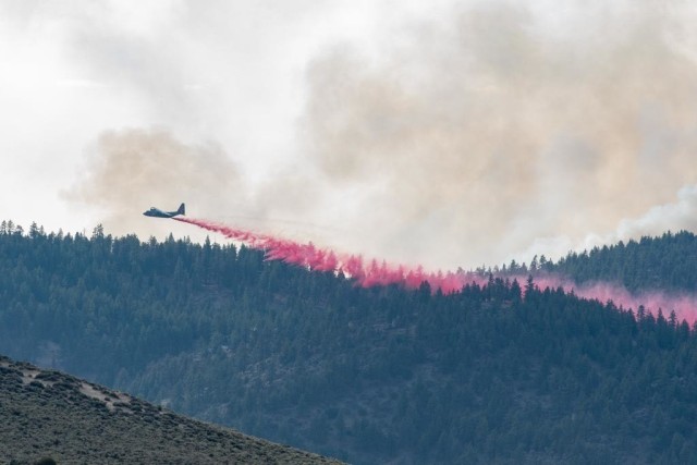 Air National Guard C-130 drops retardant on the Beckwourth Complex Fire July 9, 2021 near Frenchman Lake in N. California. In addition to other resources, three Air National Guard C-130s--two from Nevada and one from California will assist in battling the Beckwourth Complex Fire in Northern California. The USDA Forest Service activated the MAFFS-equipped Air Force C-130 aircraft through a DoD request for assistance.