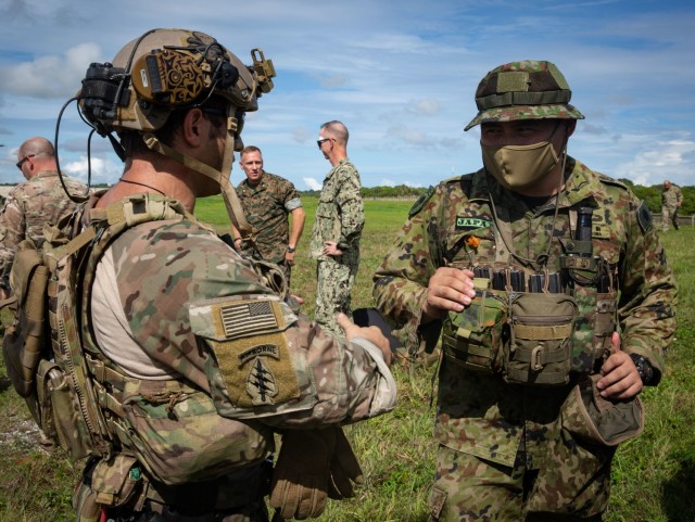 ANDERSEN AIR FORCE BASE, Guam – A U.S. Army Green Beret with 1st Battalion, 1st Special Forces Group (Airborne), discusses mission planning with a member of the Japan Ground Self-Defense Force July 30, 2021. Defender Pacific 21 is a U.S. Army...