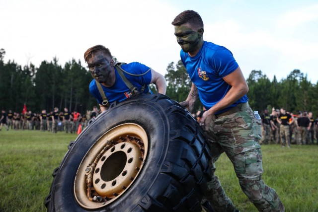 Soldiers from 3rd Battalion, 15th Infantry Regiment, 2nd Armored Brigade Combat Team, 3rd Infantry Division, Fort Stewart, Georgia work together during the tire flip portion of the Iron Spartan Fitness Competition at Fort Stewart, Georgia. The comprehensive, timed competition sought to build a team inside a team in company formations, demonstrate the physical capability of an armored brigade combat team, and show that “People First” really means preparing Soldiers to fight, win, and come home from the nation’s wars through tough, realistic training. (U.S. Army photo by Pfc. Caitlin Wilkins, 50th Public Affairs Detachment)