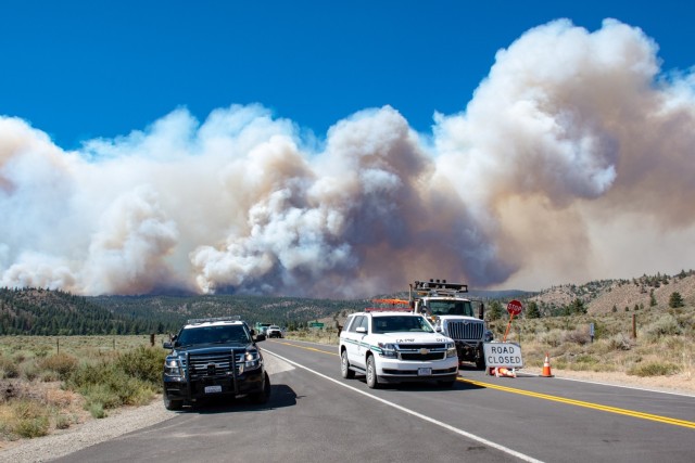 California Highway Patrolman and CalTrans employees provide road closure and safe entry and access for the firefighters and other resources in the area of the Beckwourth Complex Fire July 8, 2021 near Frenchman Lake in N. California. Many resources have been activated to contain this fire including, three Air National Guard C-130s--two from Nevada and one from California that will assist in battling the Beckwourth Complex Fire. The Air Force C-130 MAFFS-equipped aircraft, are requested by the National Interagency Fire Center and approved by the Secretary of Defense, are providing unique fire-fighting capabilities.