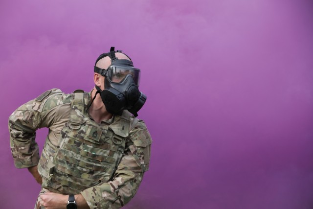 Sgt. 1st Class Tyler Price responds to a simulated chemical attack during the Army Materiel Command Best Warrior Competition in Camp Atterbury, Ind. July 25-28. Price was named AMC's noncommissioned officer of the year. (U.S. Army photo by...