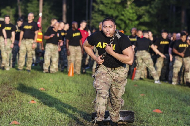 Cpl. Isaac Guzman assigned to the Headquarters and Headquarters Company, 703rd Brigade Support Battalion, 2nd Armored Brigade Combat Team, drags a 80-pound M1A1 Main Battle Tank road wheel during the Iron Spartan Competition on Fort Stewart,...