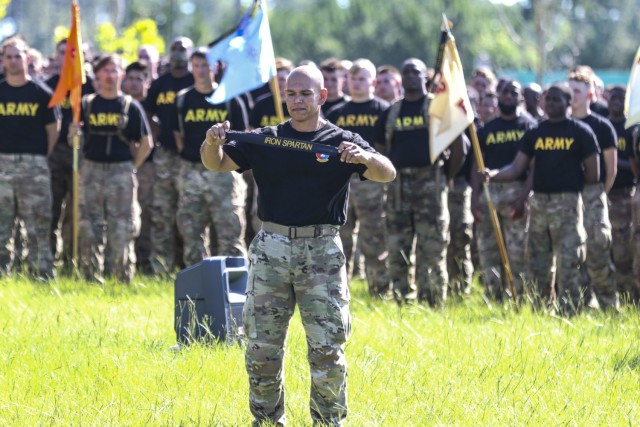 Command Sgt. Maj. Jaime Lopez, senior enlisted advisor of the 2nd Armored Brigade Combat Team, 3rd Infantry Division, displays the Iron Spartan streamer during the Iron Spartan Competition closing ceremony on Fort Stewart, Ga. June 25, 2021. The comprehensive, timed competition sought to build a team inside a team in company formations, demonstrate the physical capability of an armored brigade combat team, and show that “People First” really means preparing Soldiers to fight, win, and come home from the nation’s wars through tough, realistic training. (U.S. Army photo by Brian K. Ragin Jr.)