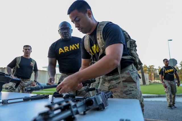Sgt. Jonathan Pardo, a fire control specialist, assigned to 1st Battalion, 9th Field Artillery Regiment, 2nd Armored Brigade Combat Team, 3rd Infantry Division, disassembles a M240B machine gun during the Iron Spartan Competition at Fort Stewart, Georgia, June 25, 2021. The comprehensive, timed competition sought to build a team inside a team in company formations, demonstrate the physical capability of an armored brigade combat team, and show that “People First” really means preparing Soldiers to fight, win, and come home from the nation’s wars through tough, realistic training. (U.S. Army photo by Spc. Jose Escamilla)