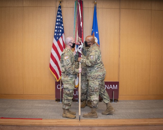 Army Brig. Gen. Shan Bagby, Regional Health Command – Central commanding general, presents Brig. Gen. Clinton Murray, Brooke Army Medical Center commanding general, with the BAMC guidon during an assumption of command ceremony in the Carolyn D....