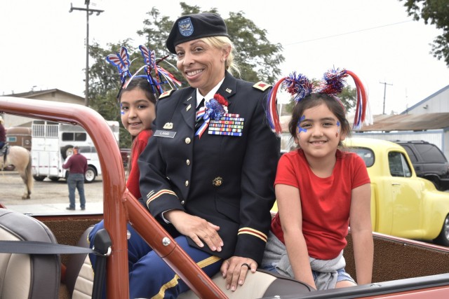 Col. Lisa M. Lamb attended the King City July 4 Parade a few days after she took command of Fort Hunter Liggett, California. She rode in a vehicle provided by the parade committee, and invited the daughters of Sgt. 1st Class Fernando Siordia, 91st Training Division, to ride along.