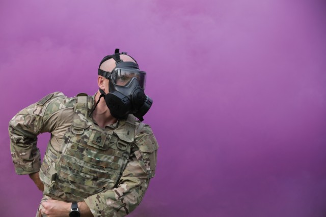 Sgt. 1st Class Tyler Price responds to a simulated chemical attack during the Army Materiel Command Best Warrior Competition in Camp Atterbury, Ind. July 25-28. Price was named AMC&#39;s noncommissioned officer of the year.  (U.S. Army photo by Samantha Tyler) 