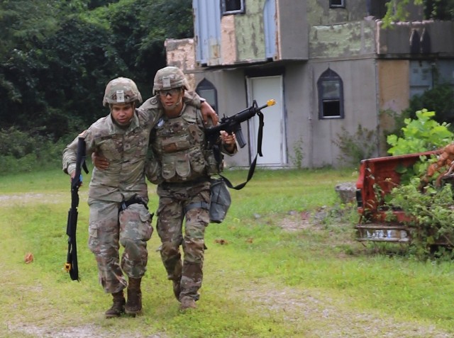 Spc. Christian Kerkado-Colon, a military policeman at Corpus Christi Army Depot, assists Sgt. Jonathan Rivera, Soldier at Military Surface Deployment and Distribution Command, to safety during the U.S. Army Materiel Command Best Warrior...