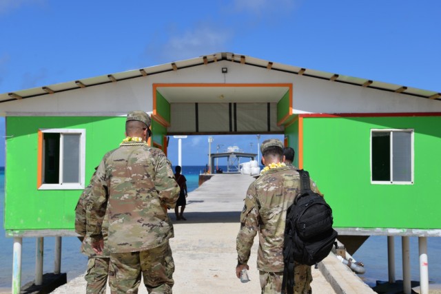 U.S. Army Garrison-Kwajalein Atoll Commander Col. Thomas Pugsley, left, and USAG-KA Host Nation Director Lt. Col. Daniel Young, right, head to the Enniburr Dock Security Checkpoint before returning to Kwajalein July 24, 2021.