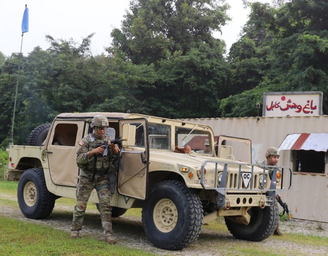 Spc. Christian Kerkado-Colon, a military policeman at Corpus Christi Army Depot, and Sgt. Jonathan Rivera, Soldier at Military Surface Deployment and Distribution Command, clear buildings during the U.S. Army Materiel Command Best Warrior...