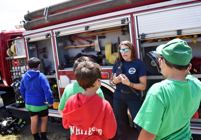 Firefighter Andrea Kiser with the Presidio of Monterey Fire Department answers questions during the Monterey Cub Scout Camp at the Presidio of Monterey, Calif., July 29.